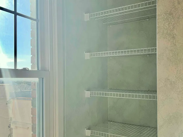 Convenient linen shelving is built-in.