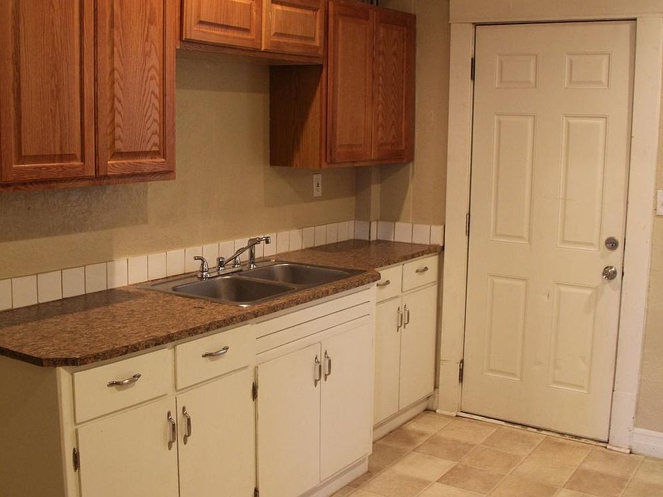 Kitchen with back door to parking area and additional storage