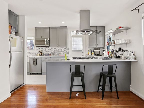 A beautiful custom kitchen with range and hook located in island