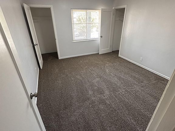 Bedroom #1 updated with fresh paint and new carpet, featuring two mid-sized closets