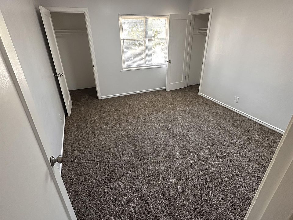 Bedroom #1 updated with fresh paint and new carpet, featuring two mid-sized closets