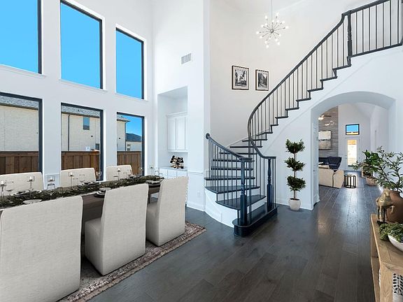 Two-story foyer with formal dining, virtually staged for demonstration