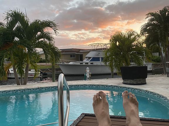 Imagine this is YOU enjoying the sunset reflected in pool, after your 1 mile swim. Just missing your yacht docked on our seawall across from the other one.