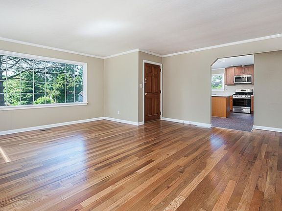 Large living room with newly re-finished hardwoods