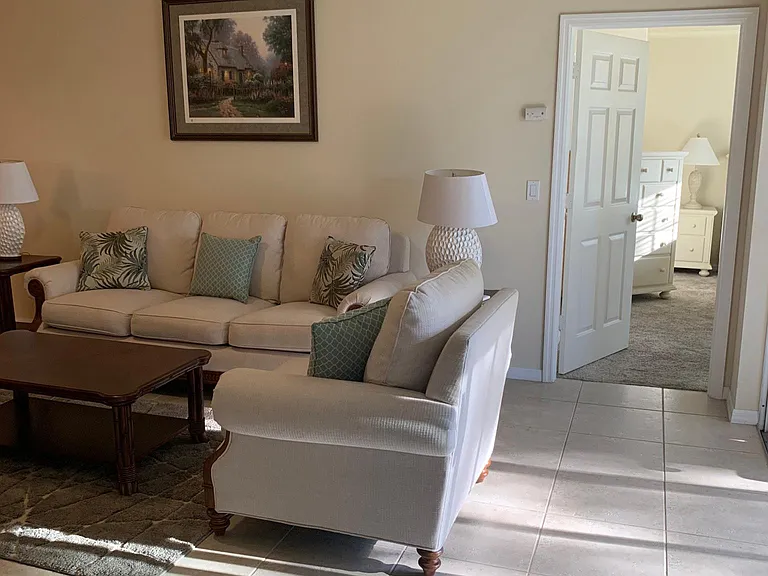 Beautifully furnished living room and dining areas with master entrance near the lanai