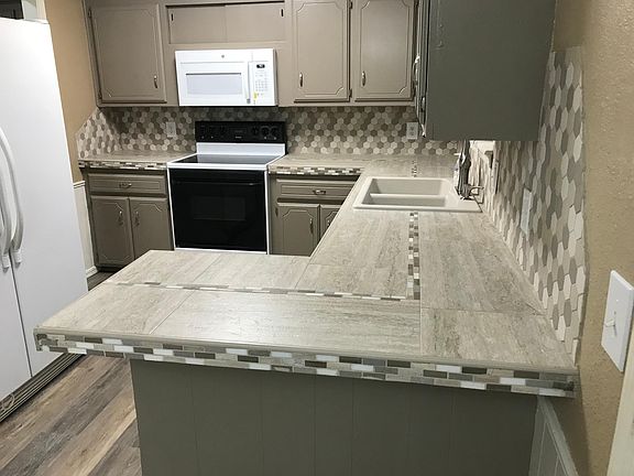 Kitchen with microwave, stove, dishwasher and stainless steel refrigerator included