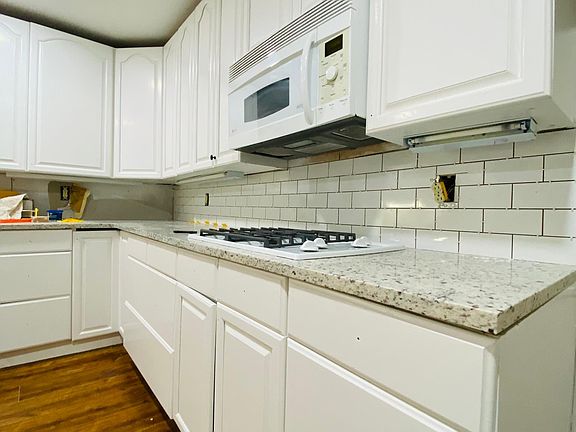 One side of spacious kitchen. Subway tile install in progress.