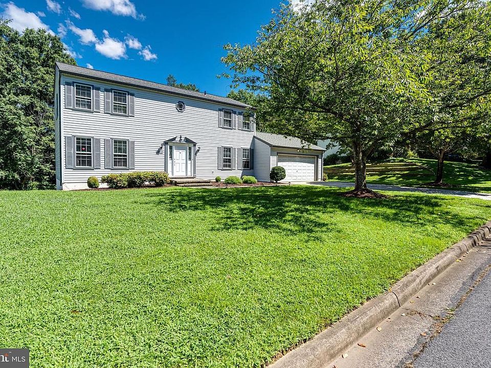 Ample green front yard with cherry blossoms