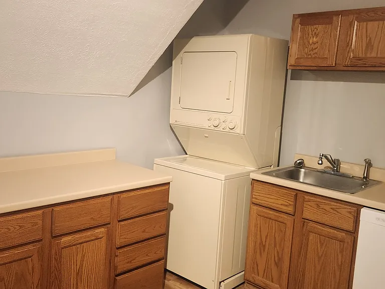 Kitchen with Washer and Dryer. Dishwasher, Stove Refrigerator. Room for a small table and chairs.