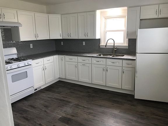 remodeled kitchen with all new cabinets, new flooring and faucet and backsplash.