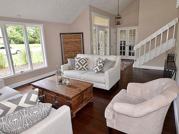 Large open entry and living room with vaulted ceiling and new bamboo hardwood floor. Glass French doors leads to formal dining room or office