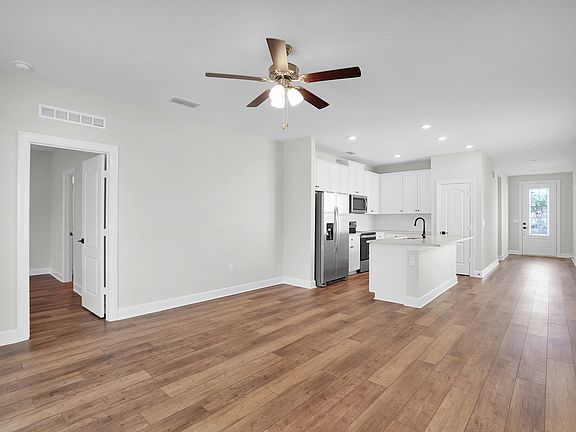 The open entertainment space includes the living room, dining room, and kitchen