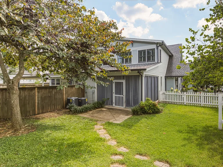 Covered dining patio leads out into the fenced-in backyard.