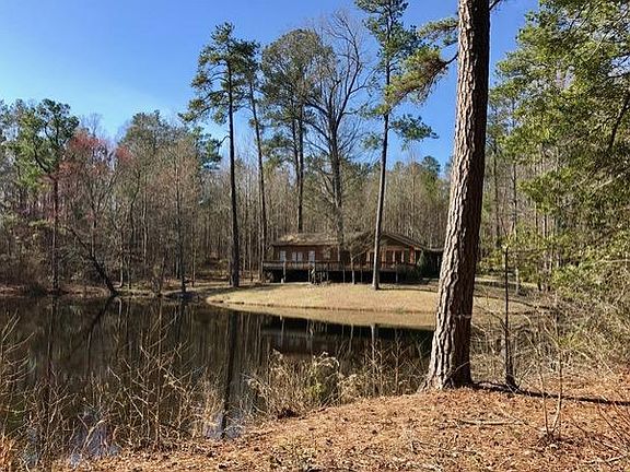 A well-positioned home overlooking a crystal clear spring feed pond. 
