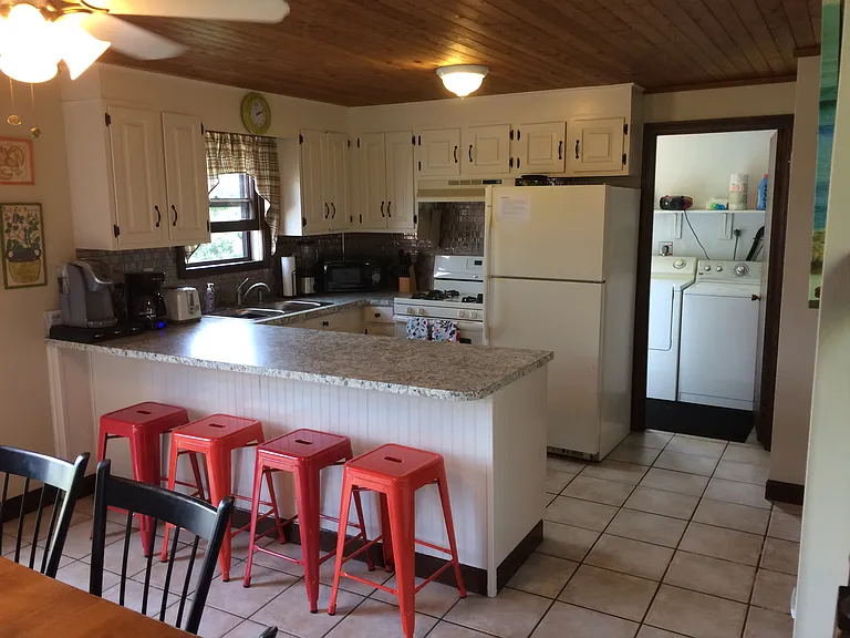 Kitchen, breakfast bar, dining table; washer and dryer in utility room