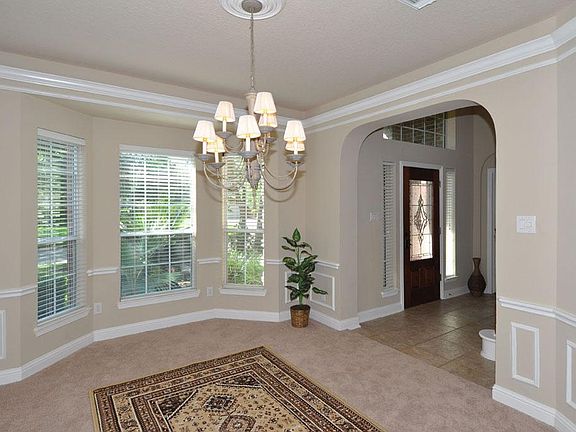 Stunning formal dining with bay window and custom paneling