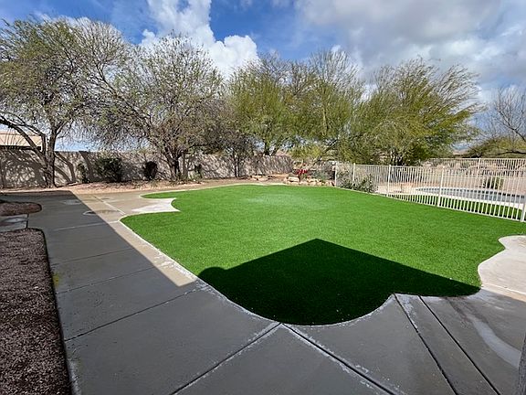 Backyard with large turf area and gated pool