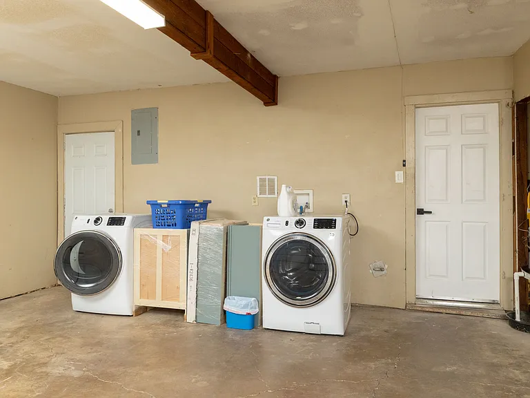Convenient garage laundry area with a modern washer and dryer, detergent provided, and plenty of space to sort and fold. Easy access makes keeping clothes fresh during your stay simple and hassle-free.