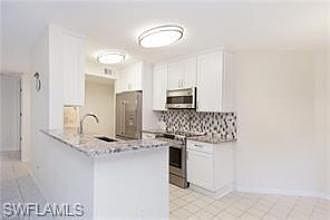Updated kitchen with stainless appliances and breakfast bar.