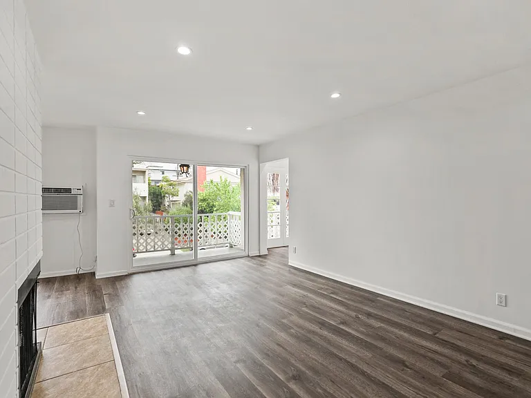 Living Room with Electric Fireplace, Recessed Lighting, Vinyl Flooring, and Patio