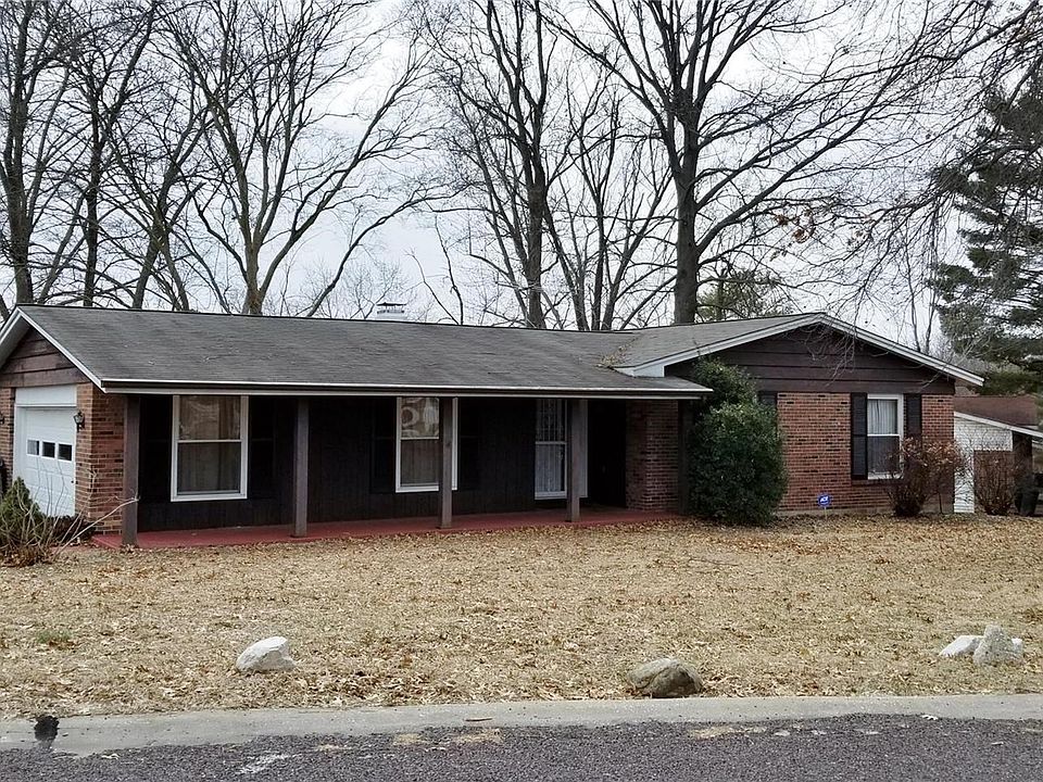 Side entry garage and covered porch accent this brick and frame ranch home with walkout, partly finished lower level.