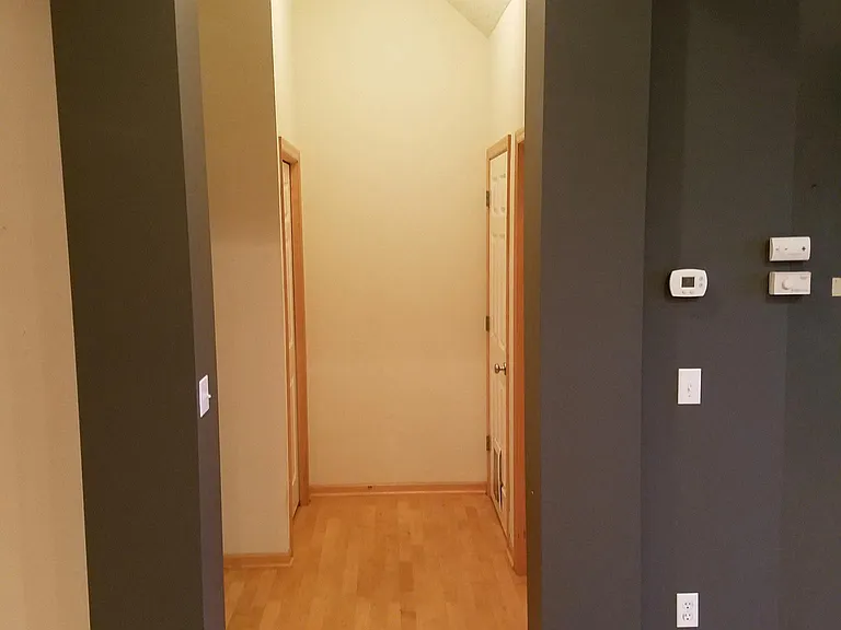 From kitchen to hallway with half bath and stairway to garag