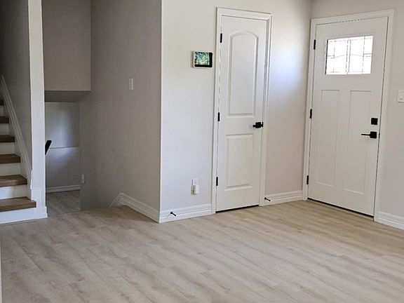 New front door, closet, vivint touch screen, steps going up to bedrooms and down to family room.
