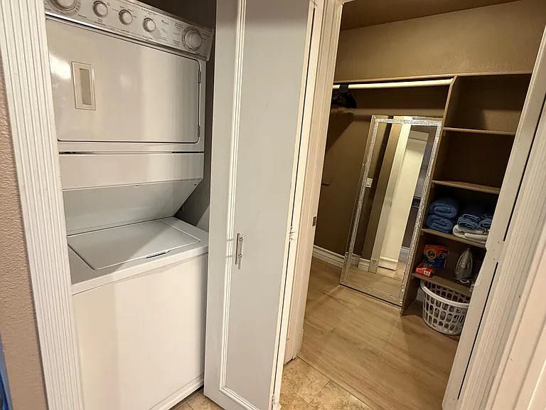 Very convenient in-unit stackable washer and dryer located next to a spacious walk-in closet, providing ample storage for extended stays.