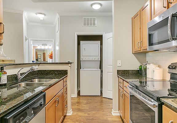 Luxurious kitchen, stainless steel appliances, stunning large islands and faux wood flooring.