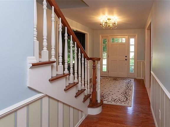 The large foyer greets you with stunning hardwood flooring and a grand staircase.