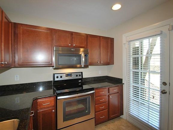 Kitchen leading to back porch and large shared backyard