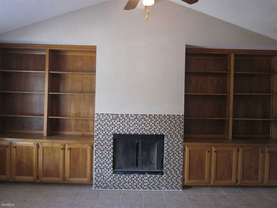 Vaulted ceiling wood fireplace storage all tile floors