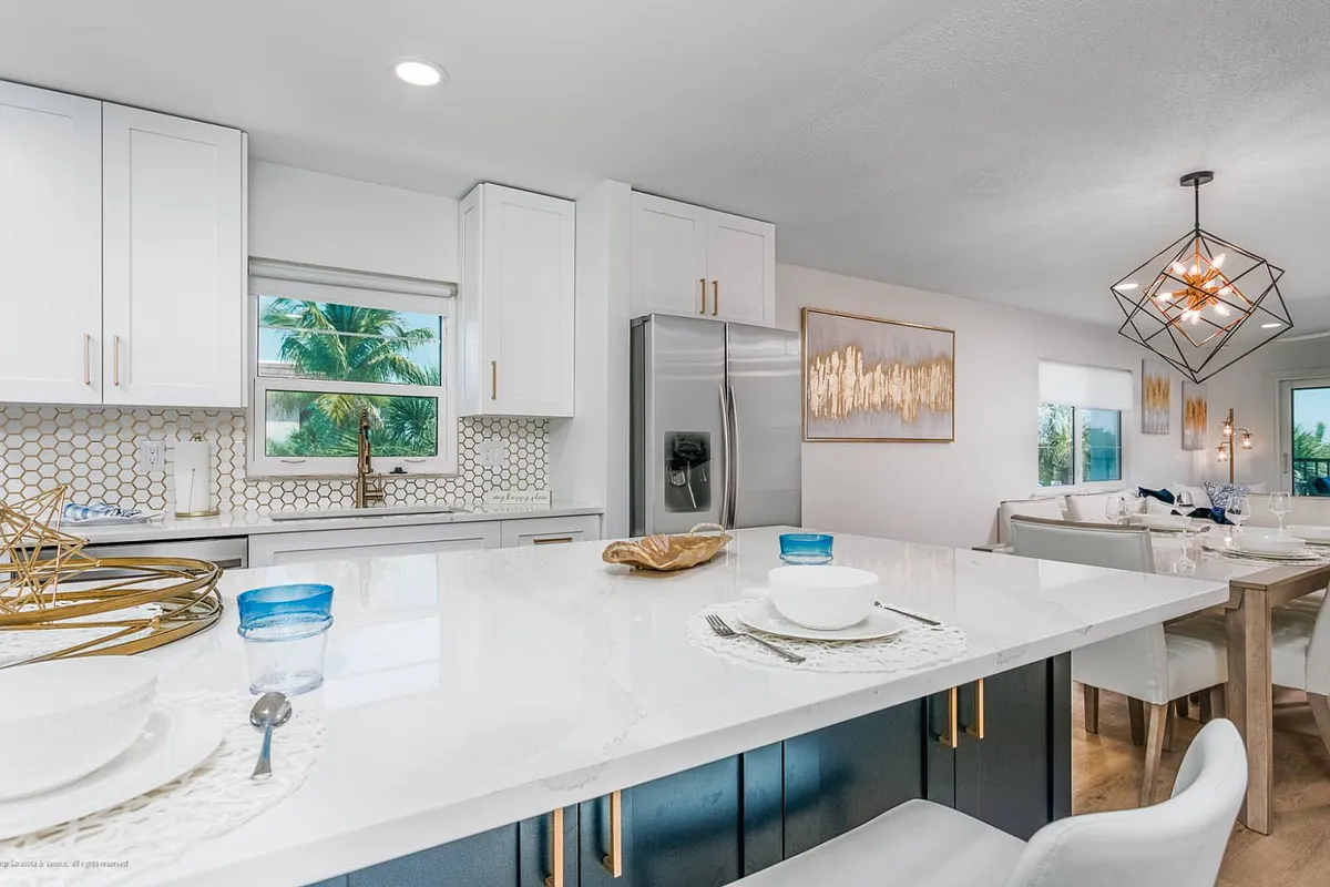 Kitchen has Carrera Marble Backsplash and Stainless Steel Appliances - 5600 Beach Way Dr #315