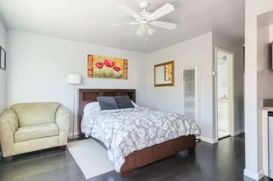 Comfy chair and queen size bed.