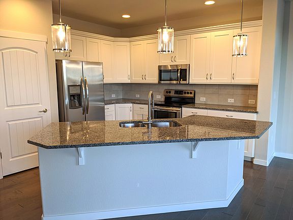 The kitchen offers an island with an informal space to eat.