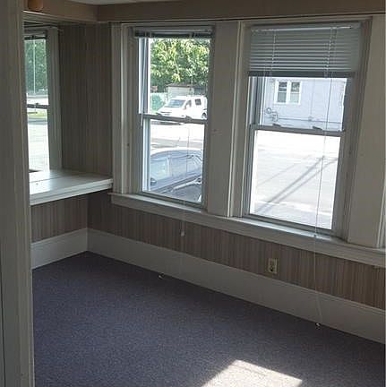 Former waiting room of the 1st floor optometrist office.  Sunny corner room and was a Florida room earlier.