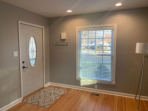 Light, bright living room with newly finished hardwood floors. Two inch blinds too.