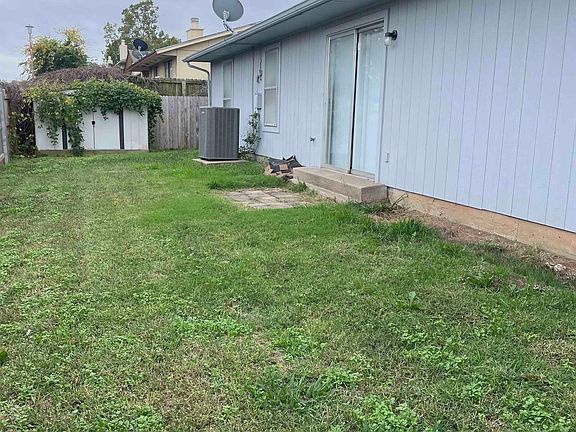 Fenced backyard with new fence