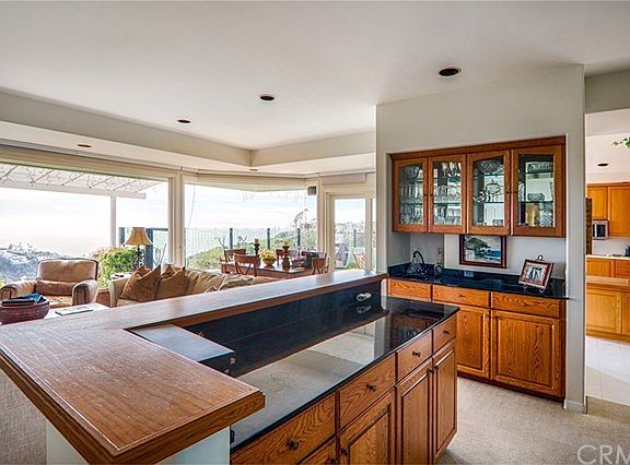 The living room features a wet bar and lots of cabinet space.