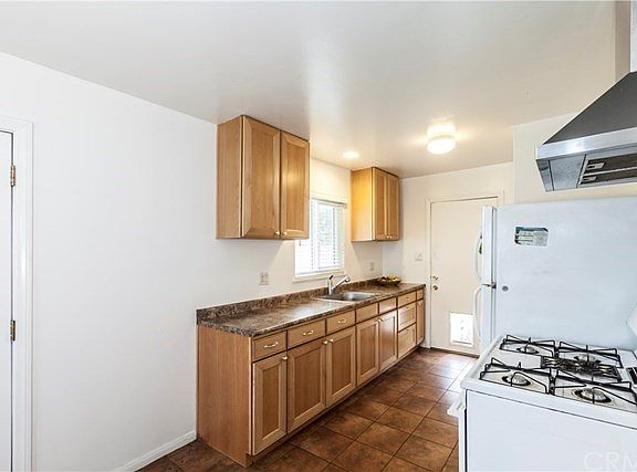 Gas stove with range/hood, back door to large backyard