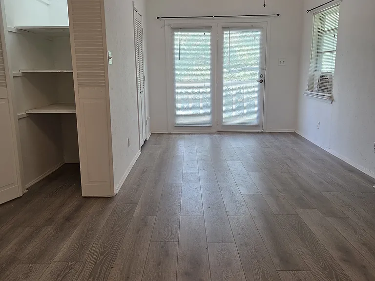 The Large bedroom is 24 feet long and 12.5 feet wide - which includes the two large closets. This room can be used as a bedroom with an office or a studio.