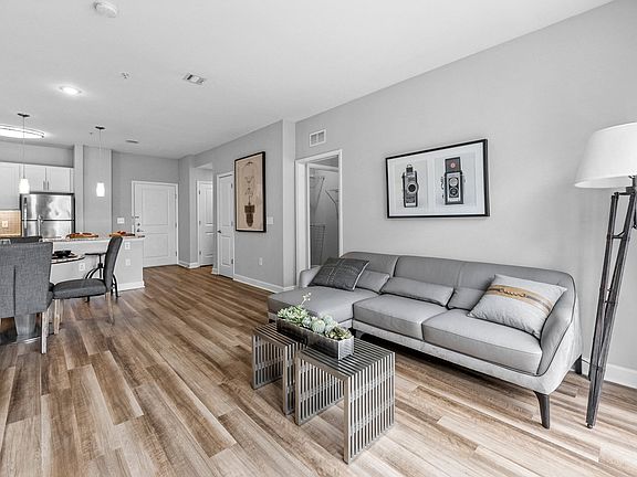 a living room with hardwood flooring and grey couch at Harbor Pointe, Bayonne, 07002