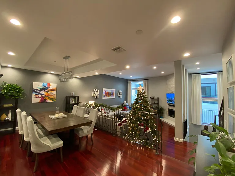 The spacious living room features high ceilings and hardwood floors