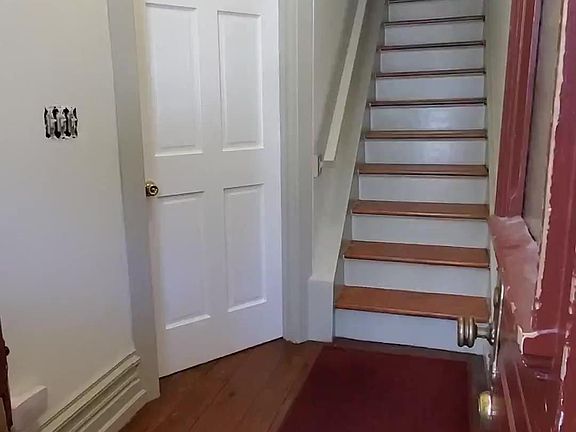 Entry door to living room and staircase to 2nd floor front.