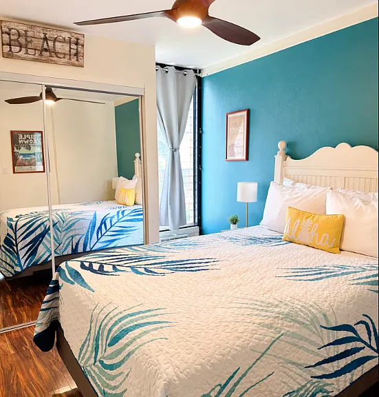 Queen size bed with AC and ceiling fan.