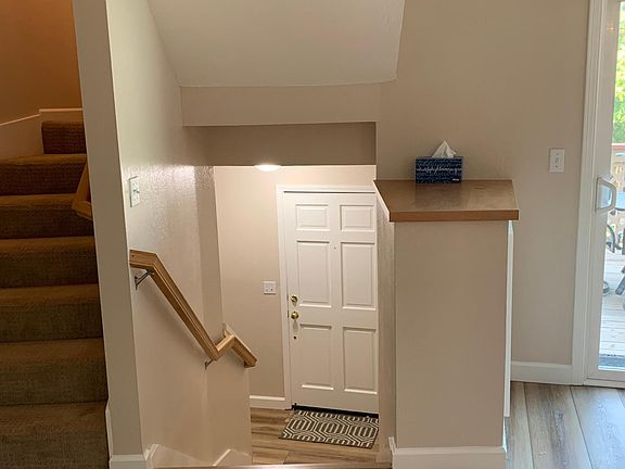 Stairs down to front door and stairs up to bedrooms.