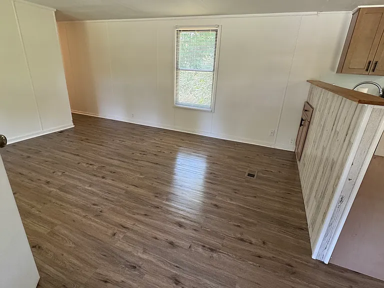Front door view of living space and kitchen.