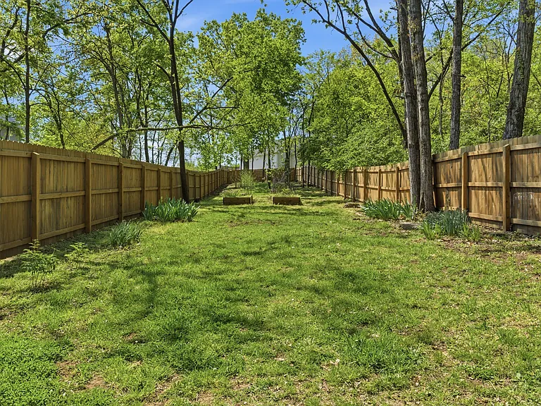 Spacious backyard lawn, fully fenced.