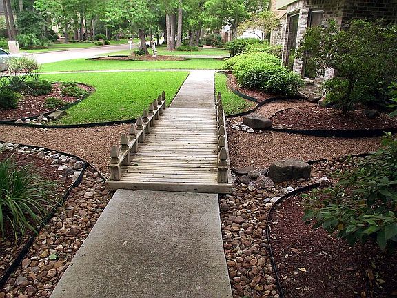 Always high+dry,RiverRock Landscaping provides beauty+drainage to street
