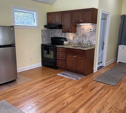 Kitchen has granite counters, oven and lots of cabinets